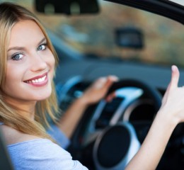 Woman in car giving thumbs up